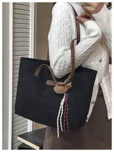 Black large capacity tote bag with brown straps and cute bear pendant, ideal for daily commute.