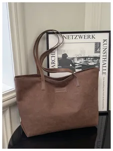 Detail view of the brown suede tote bag in a stylish scene, featuring large capacity and straps.