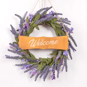 Artificial lavender wreath detail showing purple floral texture and wooden welcome sign.
