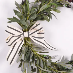 Artificial olive leaf wreath with striped bow for front door home decor detail shot