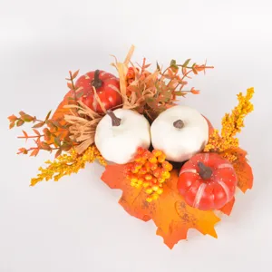 Fall artificial pumpkin and maple leaf decoration detail, harvest table centerpiece with berries.