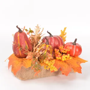 Autumn artificial pumpkin maple leaf decoration with berries and burlap base for tabletop decor.