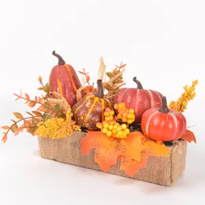 Autumn artificial pumpkin maple leaf centerpiece decoration with burlap base for holiday.