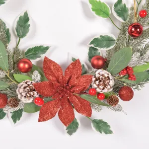 Detailed view of Christmas wreath with red poinsettia, pine cones, and frosted pine.
