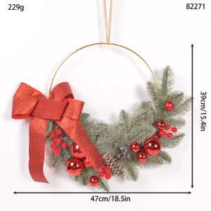 Christmas wreath decoration with pine needles red bow and berries for front door hanging.