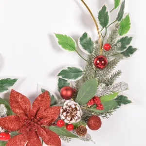 Close up of artificial Christmas wreath detail with red glitter poinsettia flower and pinecones.