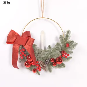Christmas decorative candlestick wreath with pine needles, red berries, bow and candle.