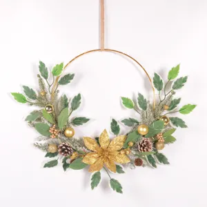 Close-up detail of artificial Christmas wreath with green leaves, pinecones and gold poinsettia.