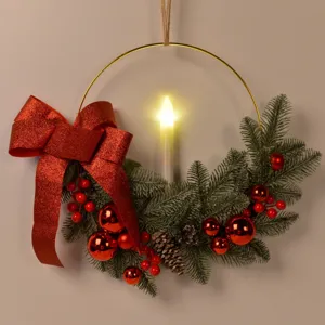 Christmas decorative wreath with gold metal ring, LED candle, red bow, and frosted pine needles.