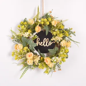 Artificial flower wreath detail featuring handmade rose and green leaves for home decor
