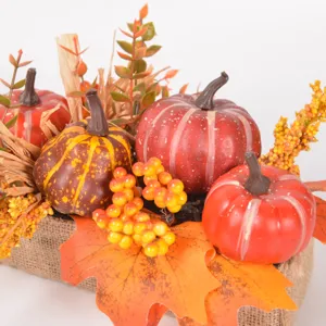 Artificial autumn pumpkin maple leaf ornament detail for Thanksgiving table center decoration.