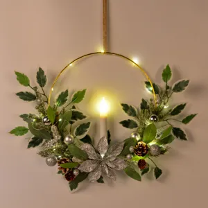 Christmas candle wreath detail, wall hanging artificial holiday decor with LED lights.