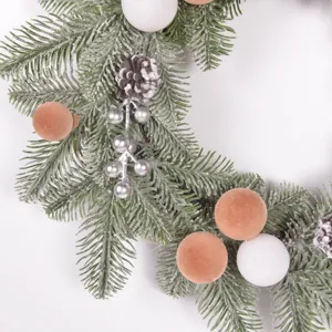 Christmas pine wreath detail ornament with frosted balls and pinecones for holiday decor