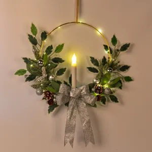 Gros plan de la couronne de Noël avec nœud scintillant, pommes de pin et bougie LED chaleureuse.