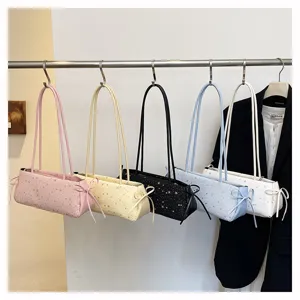 Detail of stylish star-printed shoulder bags hanging on a rack in multiple vibrant colors.
