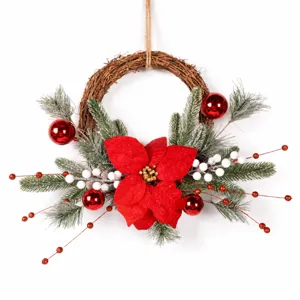 Christmas vine wreath decoration with artificial poinsettia pine branches and red berries.