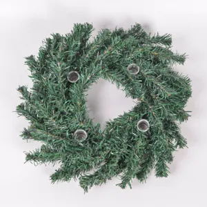 Detail view of the Christmas advent wreath with four metal candle holders and pine needles.
