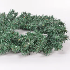 Detail shot of Christmas advent wreath with metal candle holders, artificial green pine needles.