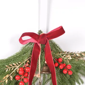 Christmas hanging wreath detail shot with red velvet bow berries and pine needles for decor