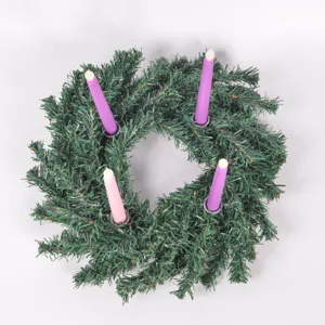 Detail shot of the Christmas advent wreath candle holder showing pine needles and candles.