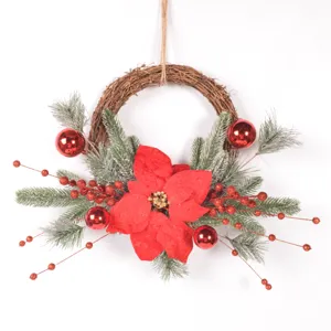 Christmas wreath detail showing poinsettia pine branches and red berries for decor