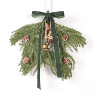 Christmas pine branch hanging decoration with pine cones, metal bells and green velvet bow.
