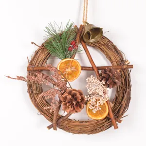 Close up of rustic Christmas wreath details with dried orange slices and natural pine cones.