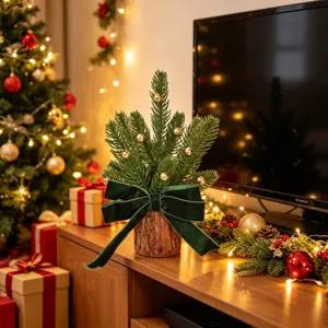 Mini Christmas tree table decoration with wooden base, green velvet bow and golden bells.