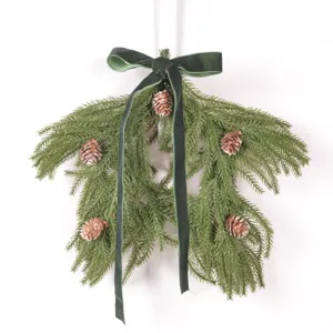Detailed view of artificial Christmas pine branch hanging decor with green velvet bow and pine cones.