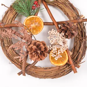 Vintage rattan pentagram Christmas wreath with pine cones and dried orange slices.