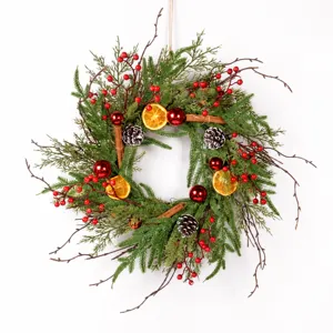 Detailed view of vintage Christmas wreath with pine needles, dried oranges and pine cones.