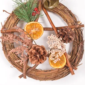 Detail view of vintage Christmas mini rattan pentagram wreath with pinecones and dried oranges.