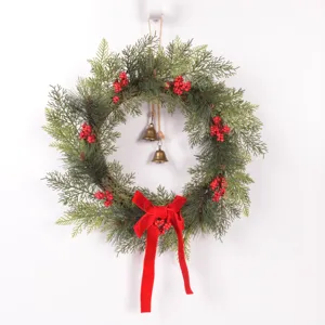 Christmas artificial pine wreath door hanging with red berries and velvet bow decor
