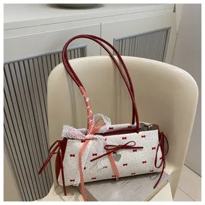Detailed view of the sweet contrast color shoulder underarm bag with lace ribbon bow design.