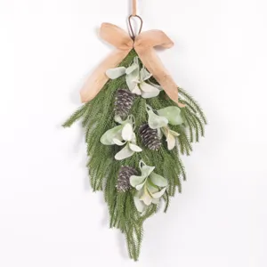 Detail shot of artificial Norfolk pine teardrop swag with lamb's ear leaves and burlap bow.