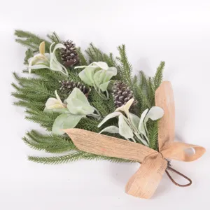 Close-up detail of artificial Christmas teardrop swag featuring pine needles and pinecones.