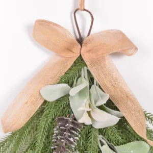 Christmas teardrop hanging decor detail featuring Norfolk pine, lamb ear leaves and bow.