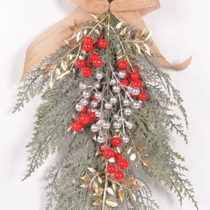 Christmas artificial pine branch teardrop swag with red berries and burlap bow detail.