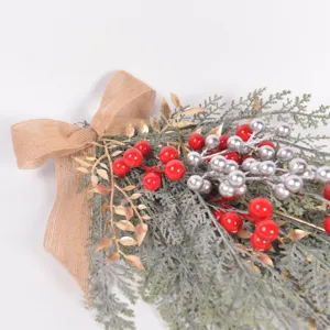 Artificial Christmas teardrop swag with pine branches red berries and burlap bow for holiday decor