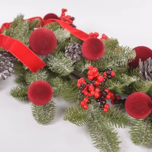 Christmas teardrop garland with flocked red balls, pine cones and berries for holiday decor.