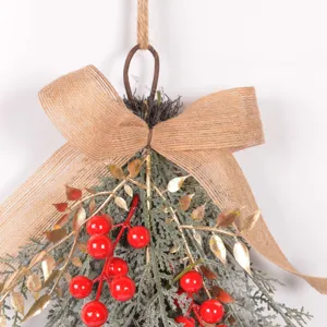 Christmas hanging artificial greenery teardrop wreath with red berries and burlap bow.