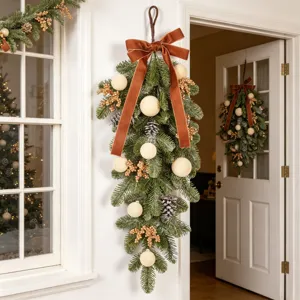 Christmas teardrop swag with flocked ornaments, pinecones and brown velvet ribbon for home decor