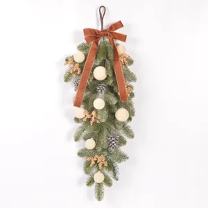 Christmas teardrop swag with flocked balls pinecones gold berries and a brown velvet bow for decor