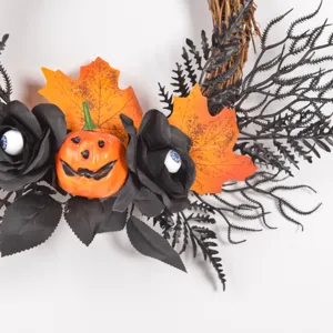 Halloween wreath detail showing black roses, spooky pumpkin and eyeballs for festive wall decor.