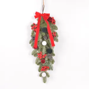 Close-up detail of Christmas teardrop swag featuring flocked pine and velvet ornaments.