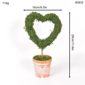 Heart-shaped moss topiary potted plant with vintage distressed pot for wedding desktop decor.