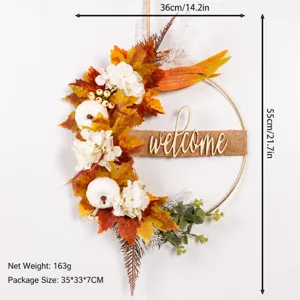 Detailed view of the autumn artificial maple leaf wreath with white pumpkins and welcome sign.