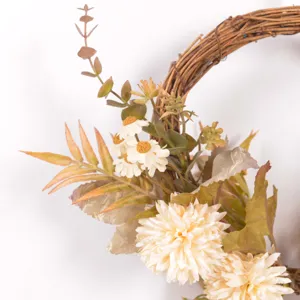 Detail shot of autumn artificial flower wreath with white daisies, eucalyptus, and retro leaves.