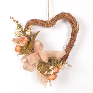 Detailed view of vintage heart-shaped twig wreath with faux roses and burlap bow decor.