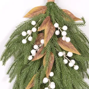 Norfolk pine artificial Christmas swag with white berries and brown leaves for wall hanging decor.